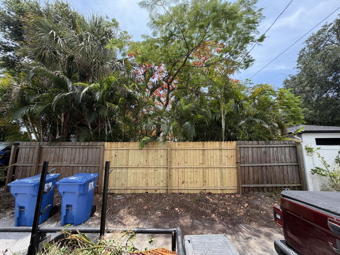 New wood fence section installed between existing panels in St. Petersburg, FL